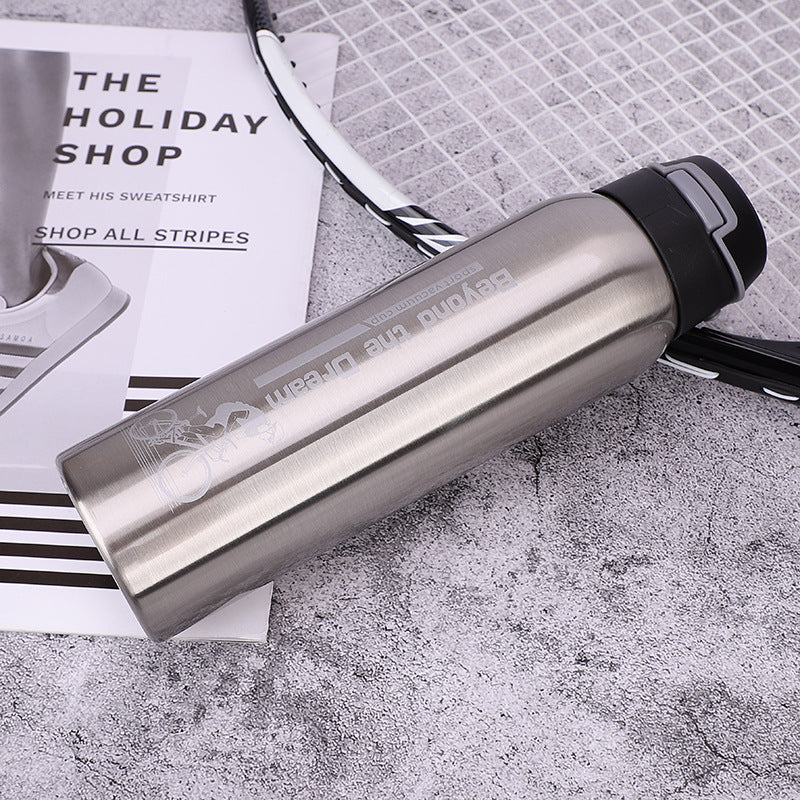 Silver stainless steel thermal bicycle bottle with 'Beyond the Dream' branding on a textured surface.