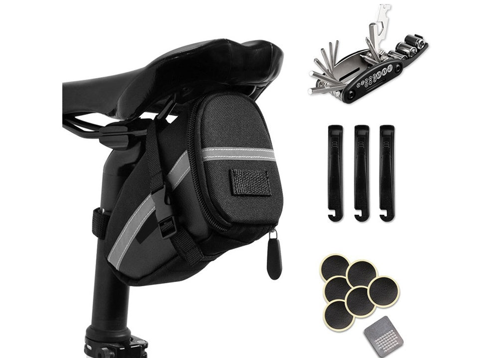 Black bike saddle bag with tools and accessories on a white background