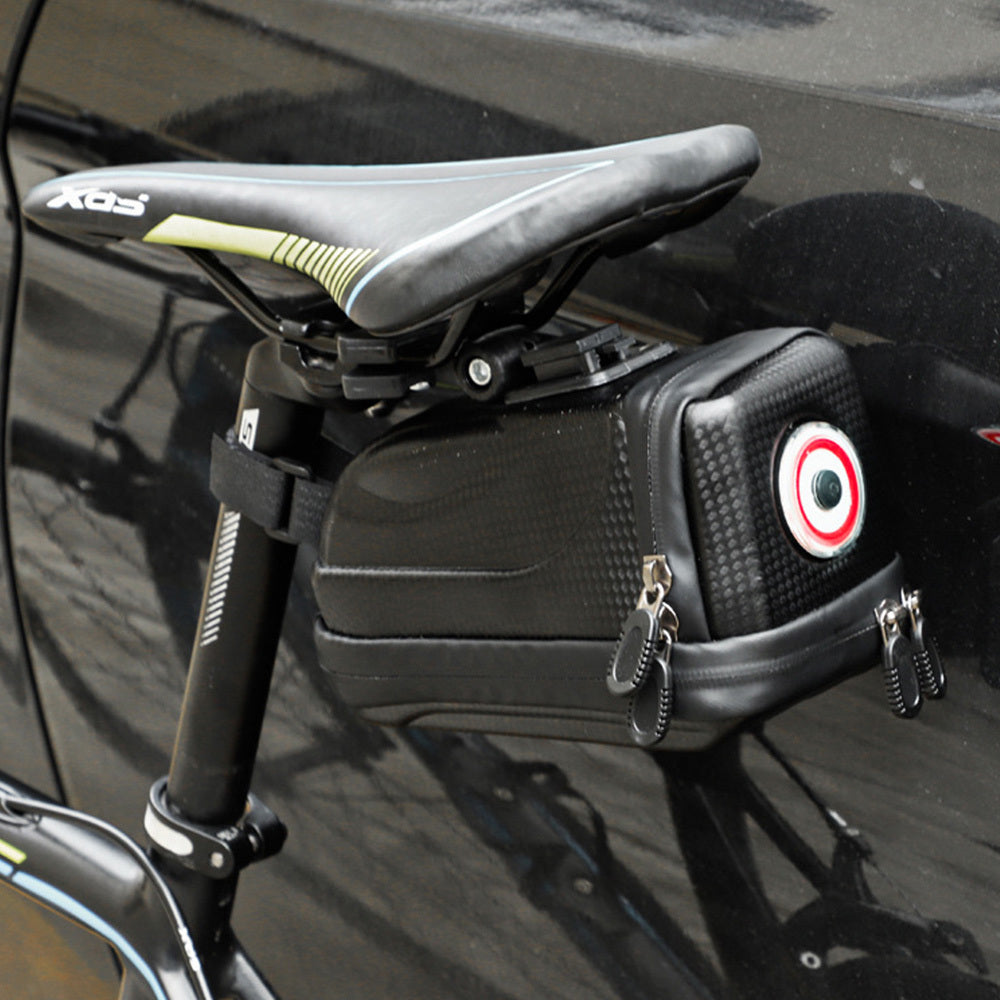 Bicycle saddle with attached black bag featuring an integrated rechargeable light on a reflective surface