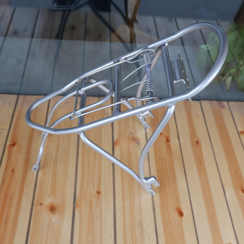 Silver metal bike rack on a wooden deck