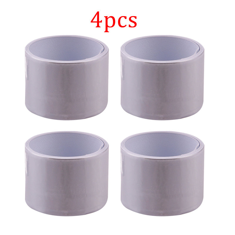 Four white reflective cycling leg bands on a white background.