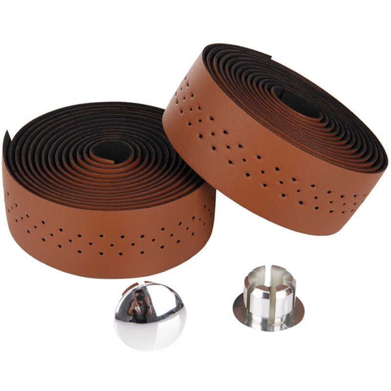 Two rolls of brown leather bar tape with chrome plugs on a white background