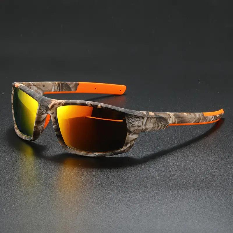Camouflage polarized cycling sunglasses with orange accents on a dark surface