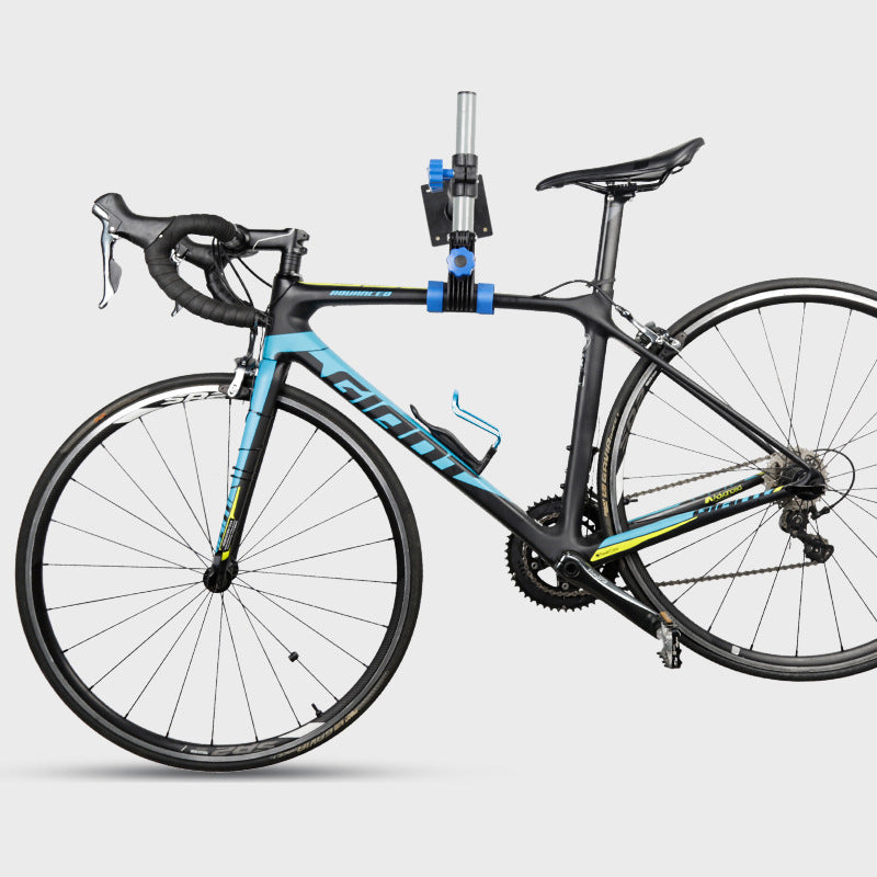 Giant bicycle on a Wall-mounted Bicycle Maintenance/Storage Support against a white background