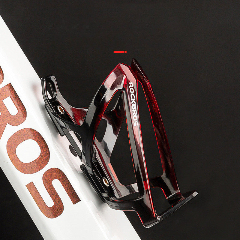Black and red 2-Tone Bicycle Water Bottle Holder/Cage on a dark background