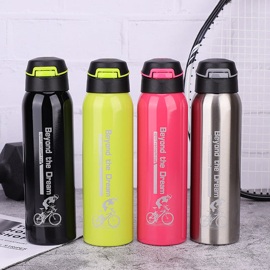 Four coloured thermal bicycle bottles with 'Beyond the Dream' branding on a gray surface.