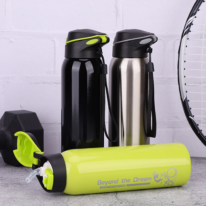Three coloured thermal bicycle water bottles on a surface with a white brick wall background.
