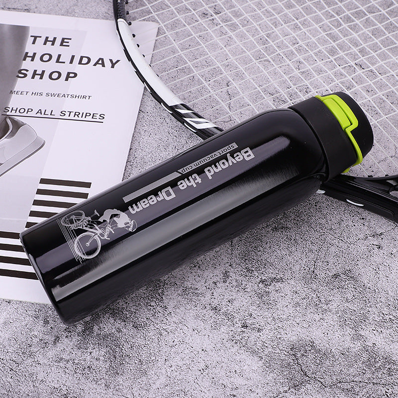 Black and yellow stainless steel thermal bicycle bottle with 'Beyond the Dream' branding on a textured surface.