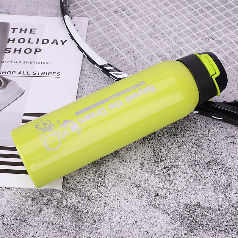 Yellow stainless steel thermal bicycle bottle with 'Beyond the Dream' branding on a textured surface.
