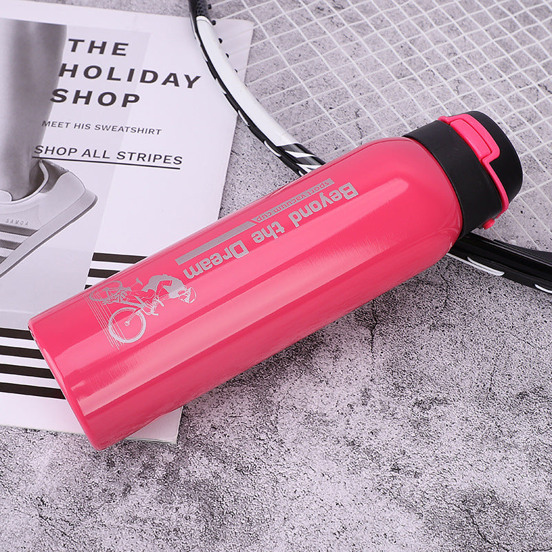 Pink stainless steel thermal bicycle bottle with 'Beyond the Dream' branding on a textured surface.