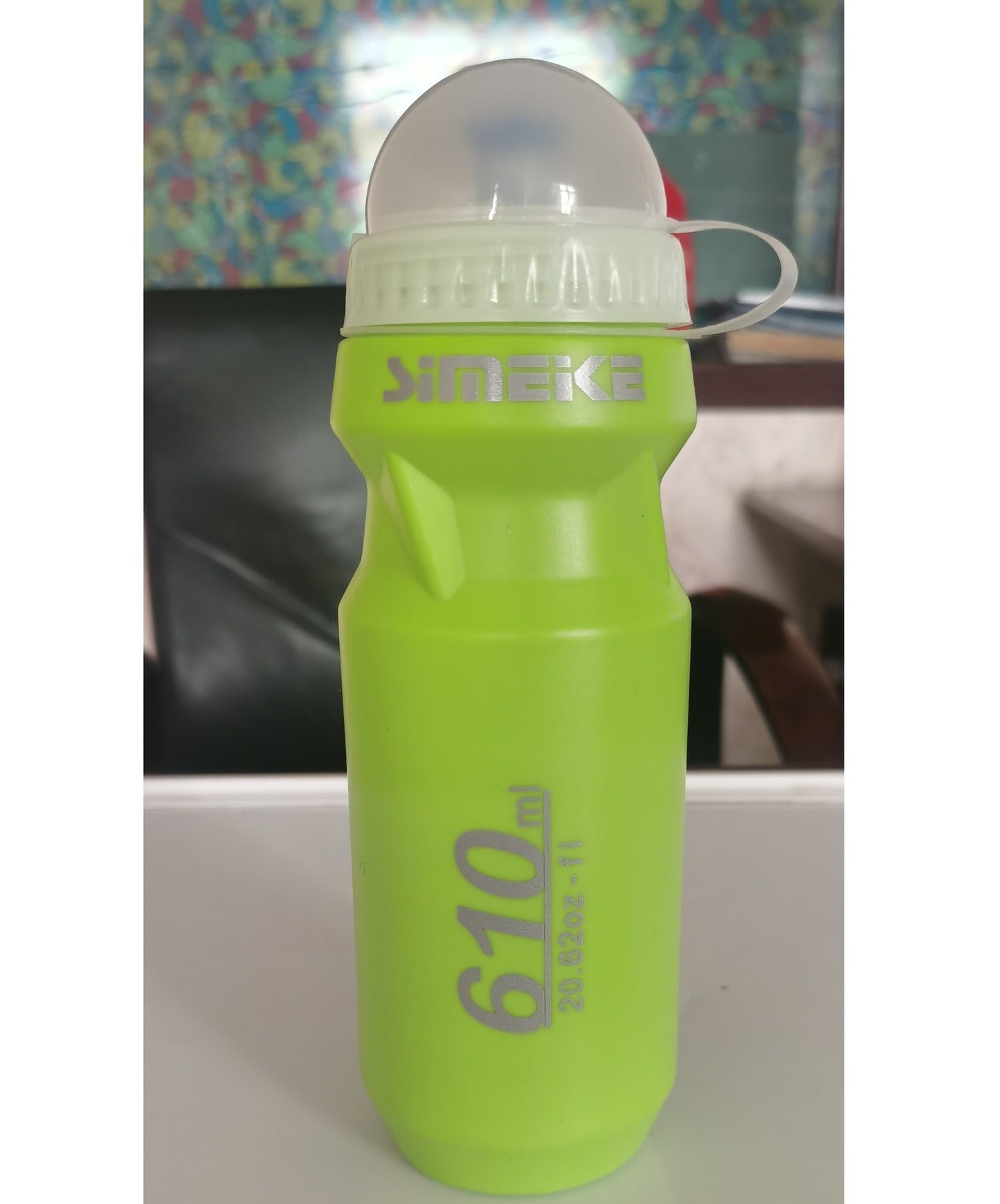 Green cycling water bottle with SIMEK branding on a white surface
