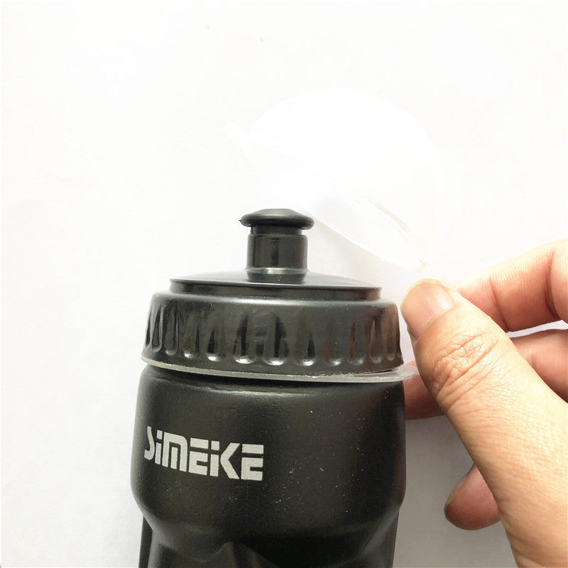 Black bicycle water bottle with black cap on a light gray background