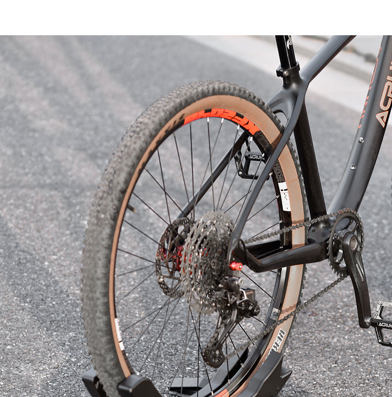 Bicycle supported in a black stand with an asphalt background