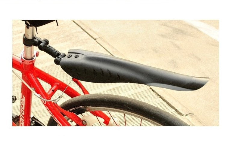 Black bike fender attached to a red bicycle on a concrete surface