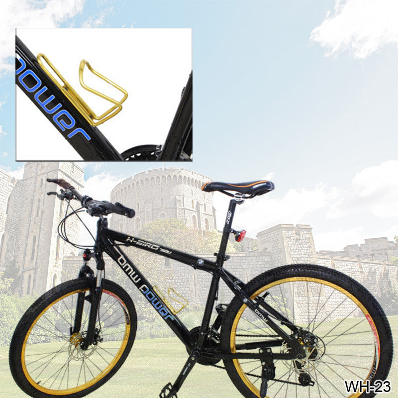 Black bicycle with gold rims and gold aluminium water cage against a white background.