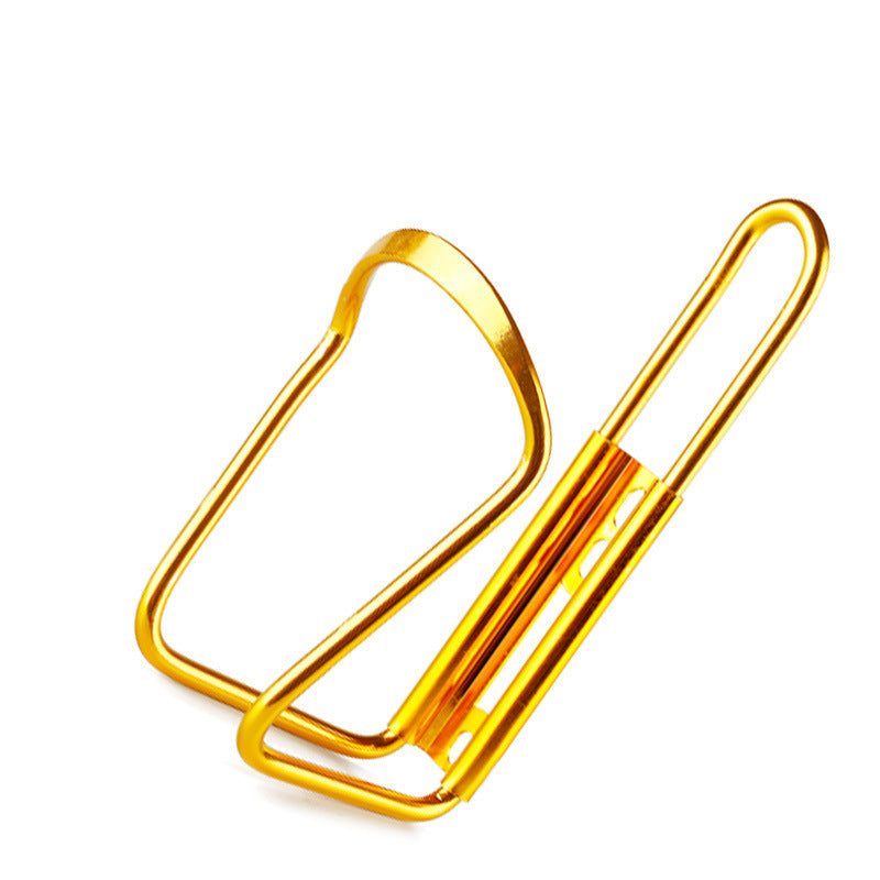 Gold aluminium bicycle bottle cage on a white background