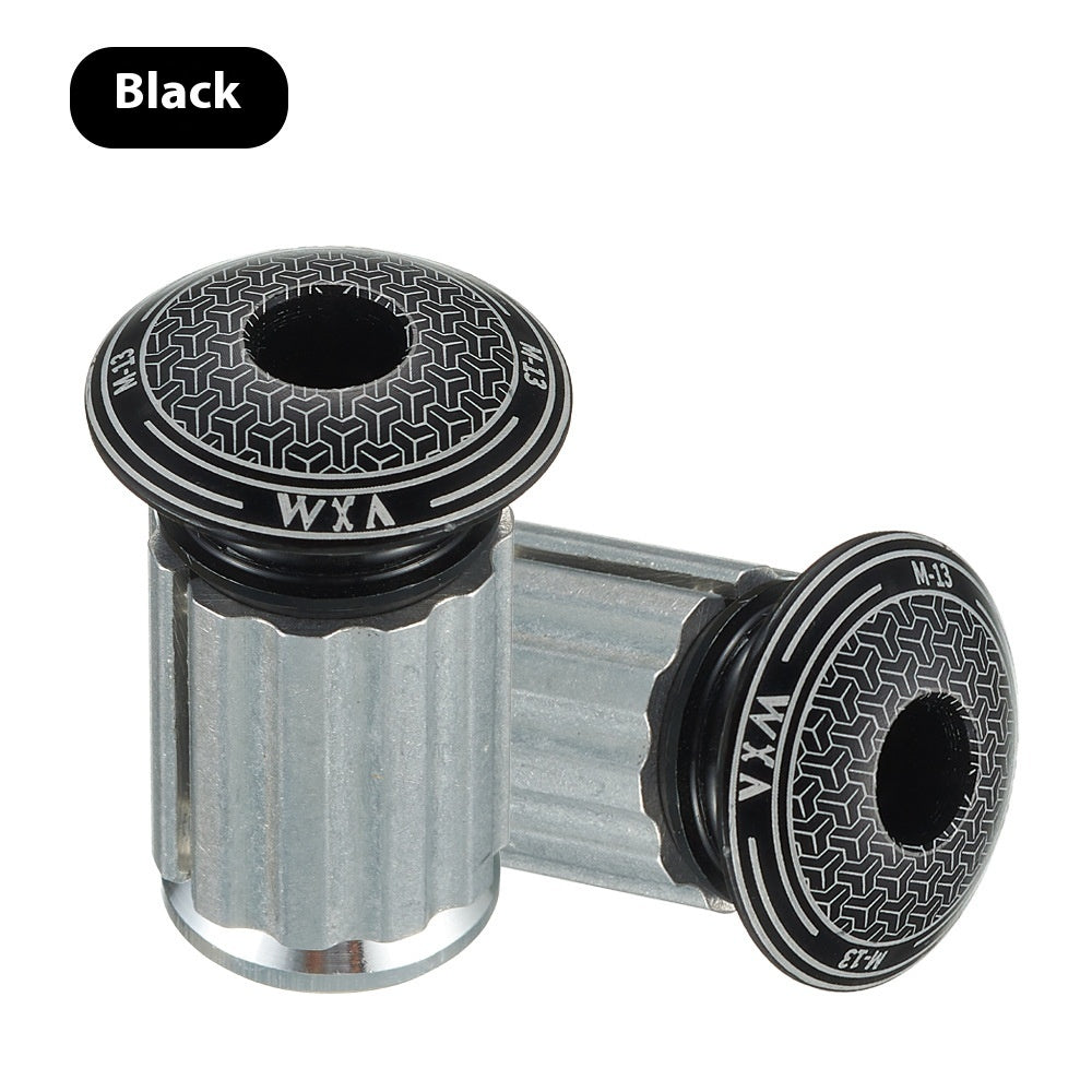 Two black and silver aluminium alloy handlebar plugs with 'WXA' branding on a white background.