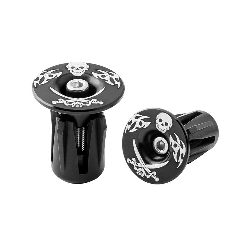 Black Aluminum Alloy Bicycle Handlebar Plugs with skull and tribal designs on a white background