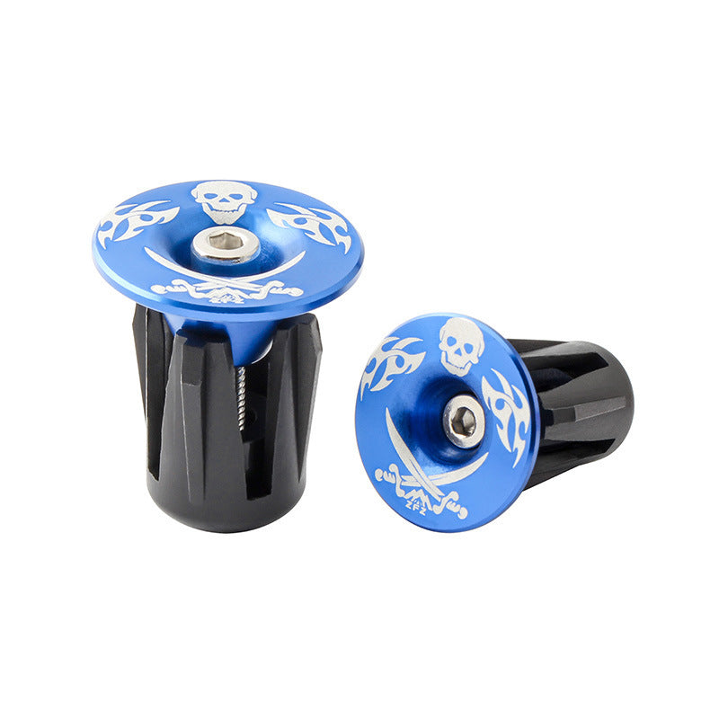Two blue and black Aluminum Alloy Bicycle Handlebar Plugs with skull designs on a white background