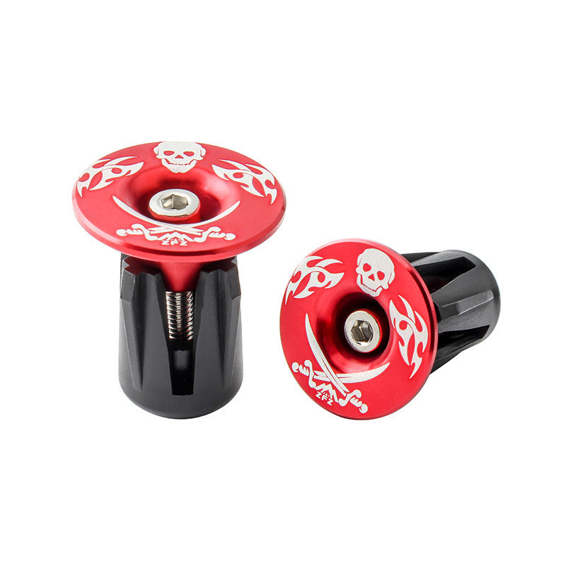Two red and black Aluminum Alloy Bicycle Handlebar Plugs with skull and crossbones design on a white background