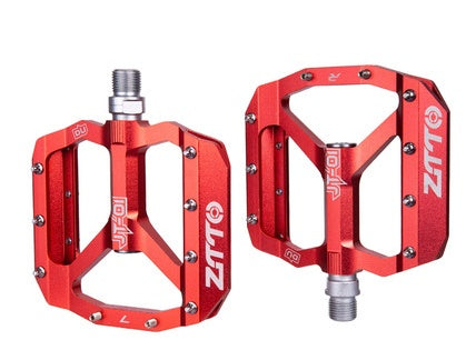 Red bicycle pedals with on a white background