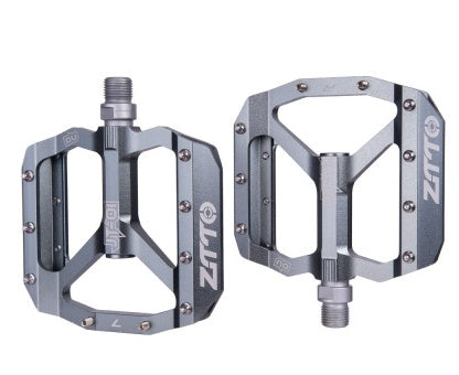 Pair of gray bicycle pedals on a white background
