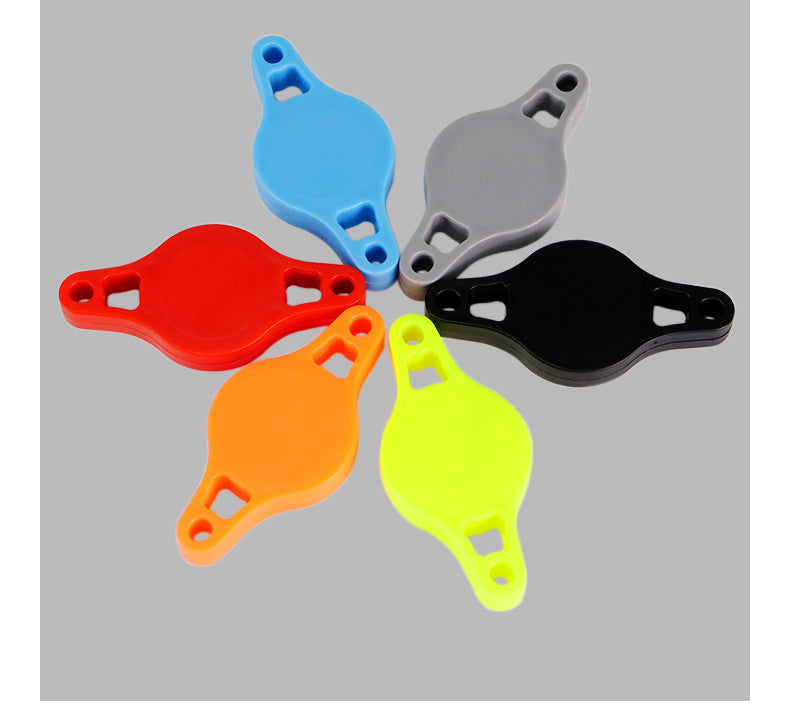 Five colorful plastic Bicycle Airtag Tracker Protective Mounts arranged in a circle on a gray background