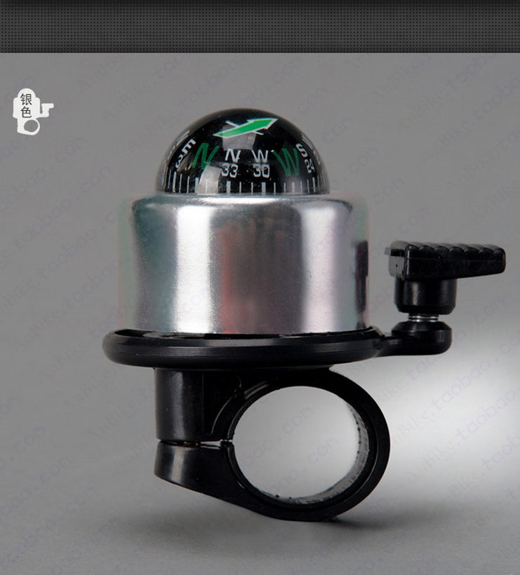 Bicycle bell with compass on a gray background