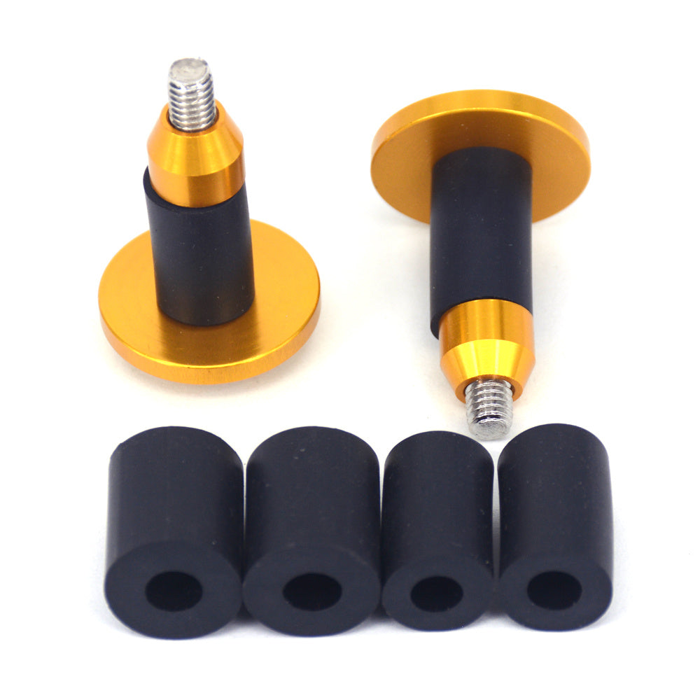 Two gold and black aluminium Bicycle Handlebar Plugs with four black rubber sleeves on a white background