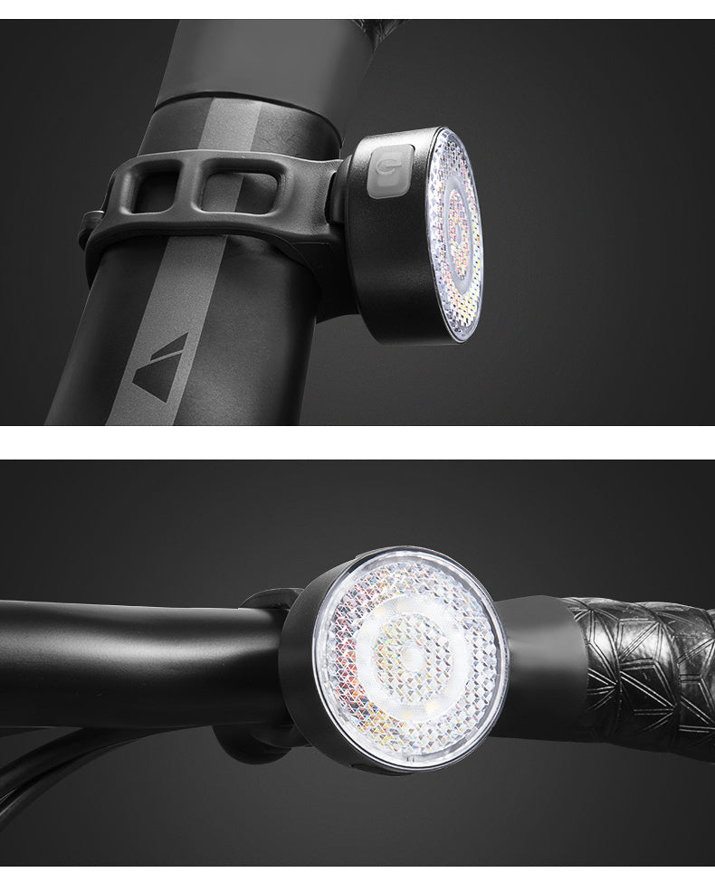 Bicycle lights attached to handlebars on a black background