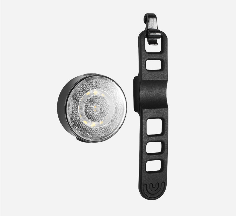 Black bike light with clear lens on a white background