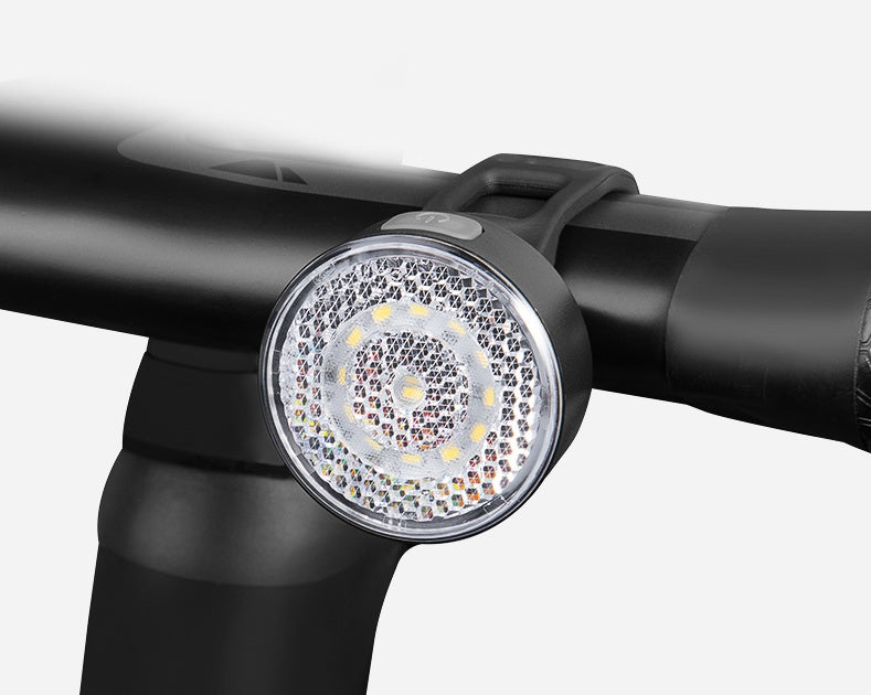 Bicycle light attached to a handlebar on a white background
