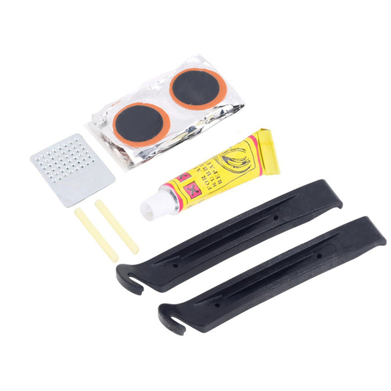 Bicycle Puncture Repair Kit with tools and materials on a white background
