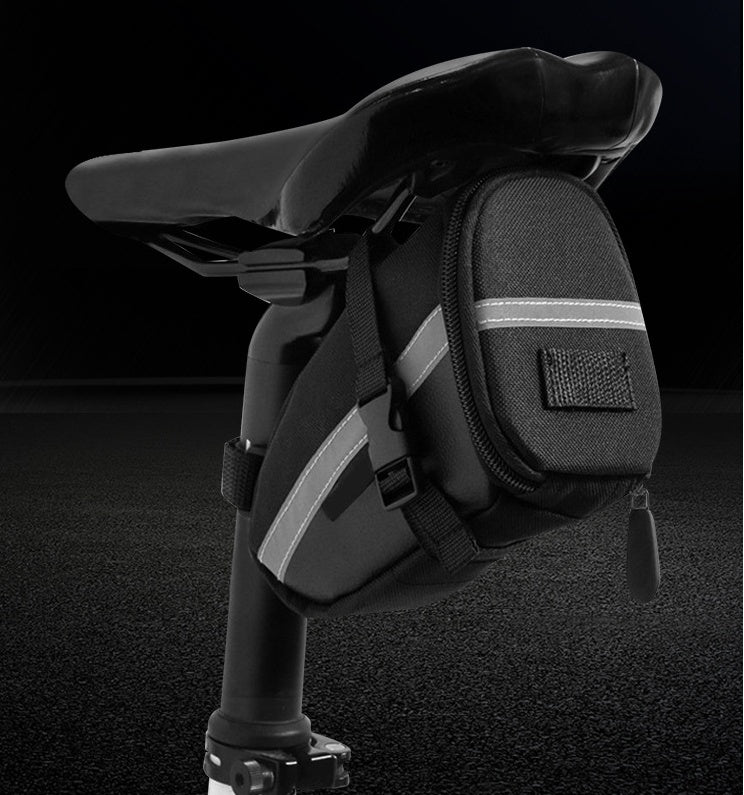 Black saddle bag with reflective stripes on a dark background