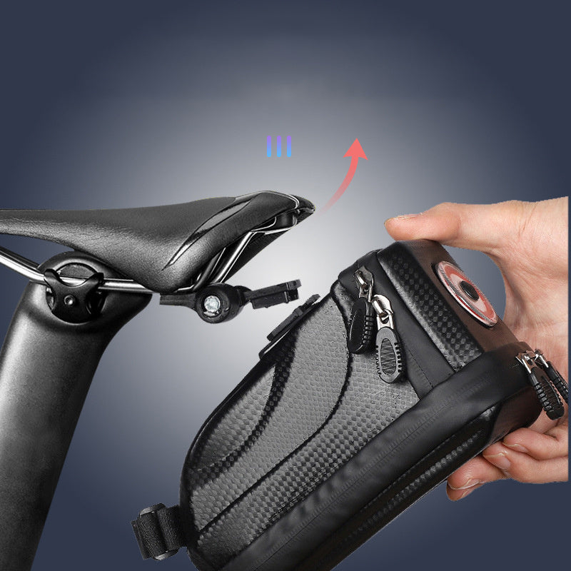 Bicycle saddle bag being attached to a bike seat with a hand holding it.