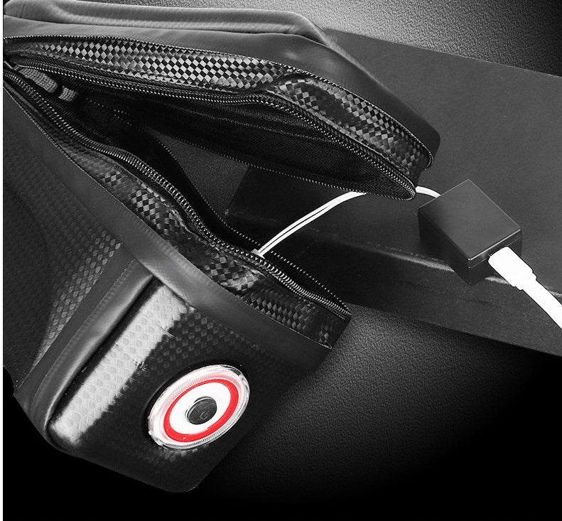 Black bag with a USB cable and integrated rear light on a black background