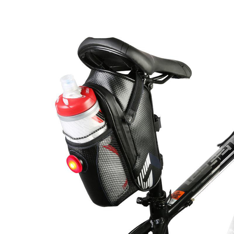 Bicycle saddle bag with water bottle holder, white water bottle and light on a white background