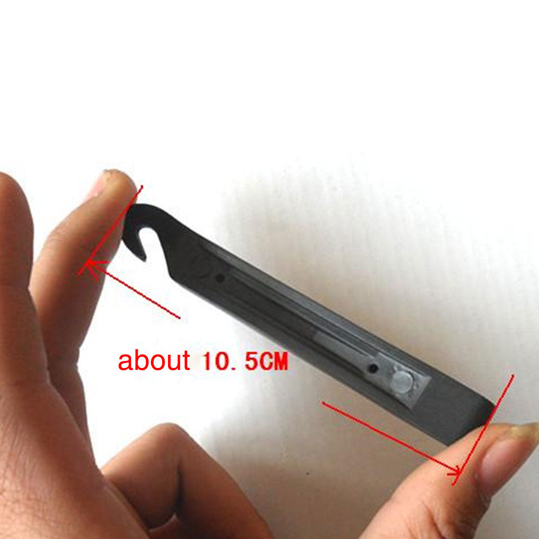 Black Bicycle Tyre Lever held by a hand with measurement label 'about 10.5CM' on a white background