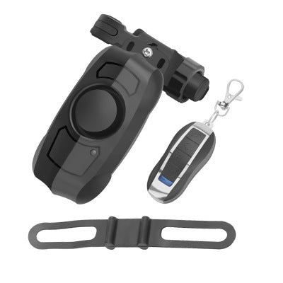 Black bicycle alarm with remote control and attachment strap on a white background