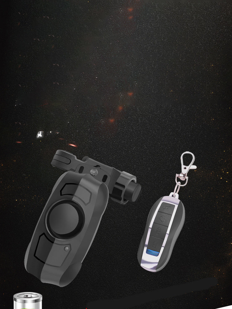 Bicycle alarm with remote control unit on a reflective black surface