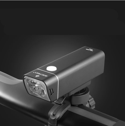 Bicycle light attached to a bike frame with a dark background