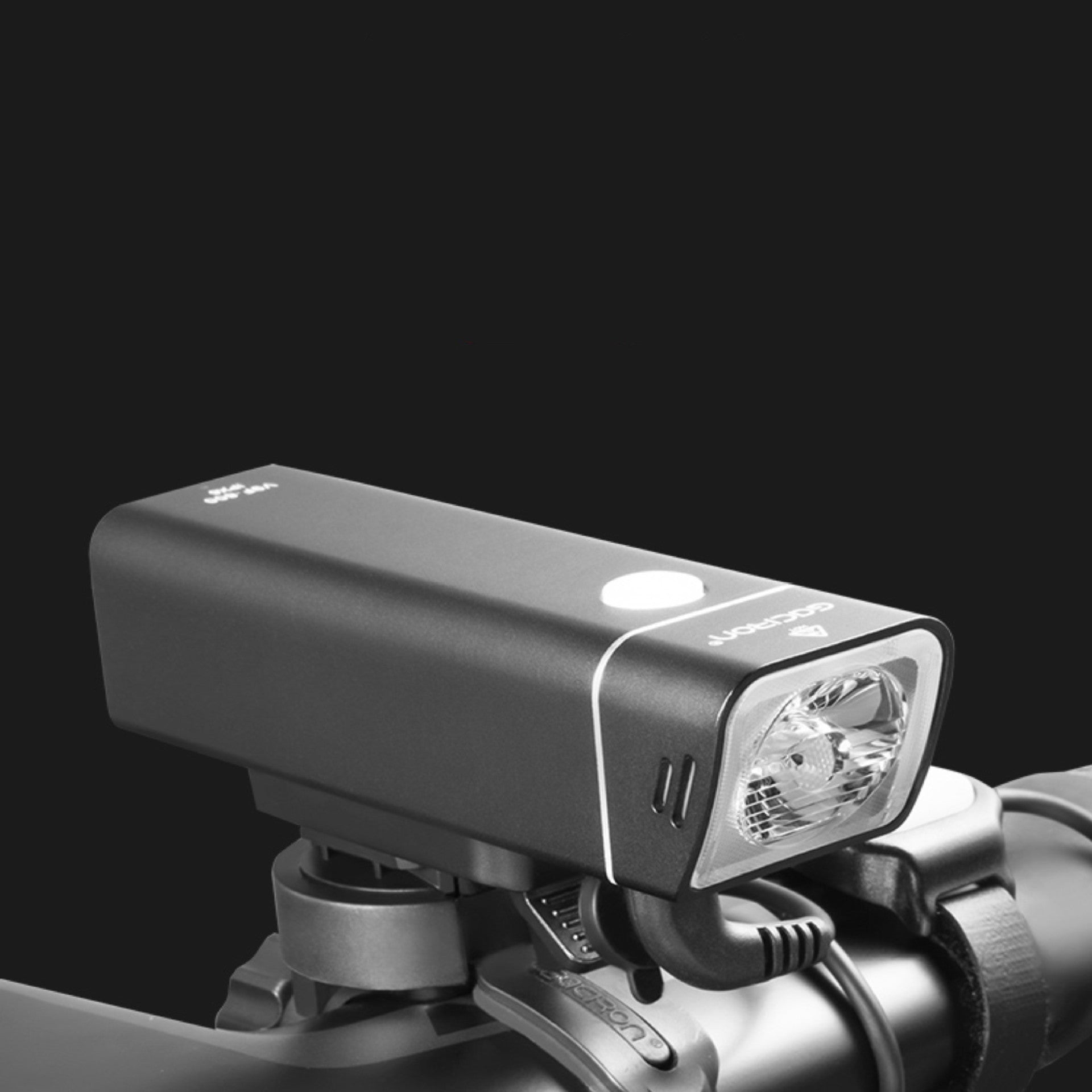 Bicycle light attached to a bike handlebar with a black background