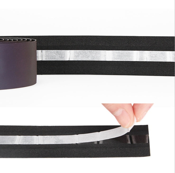 Black CX-85 Reflective Bicycle Handlebar Tape with adhesive strip held by a hand on a white background