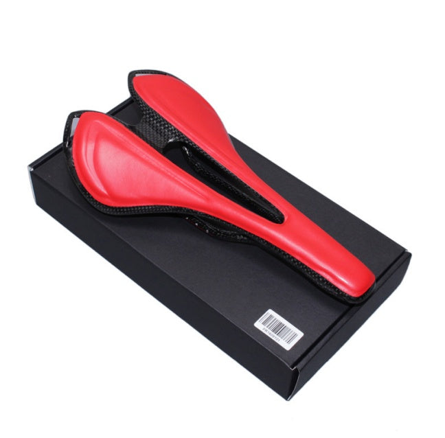 Red carbon fibre bicycle saddle in a black box on a white background
