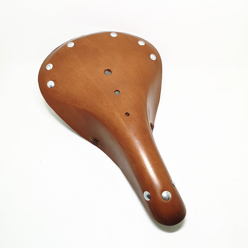 Tan vintage design leather bicycle seat with silver rivets on a white background