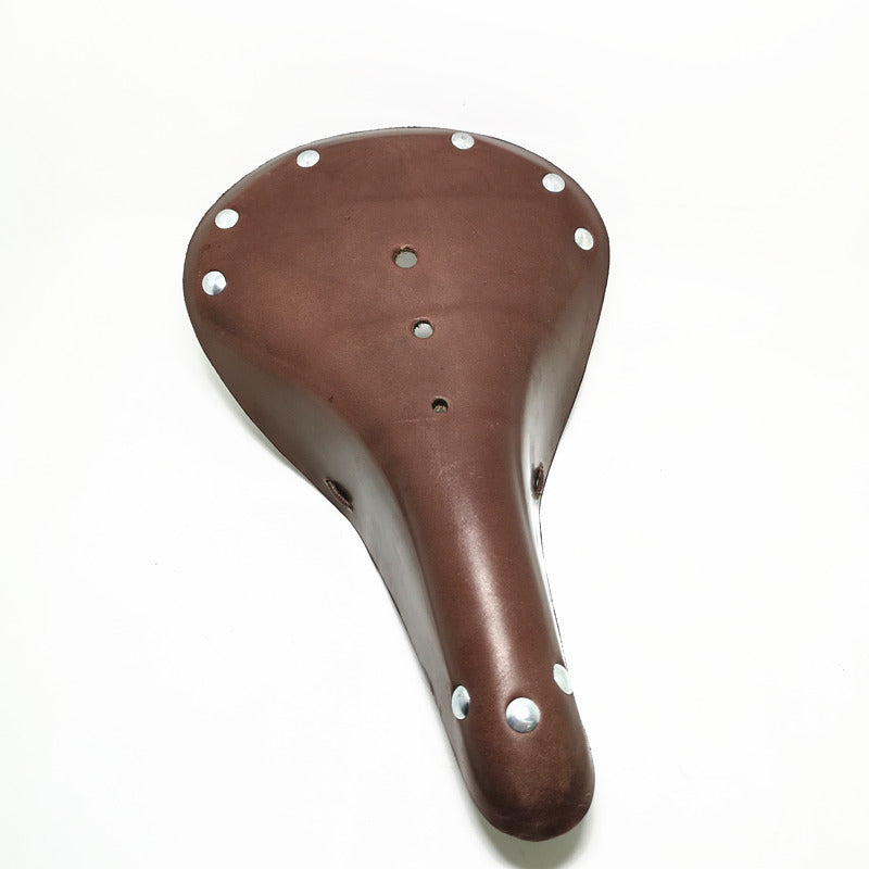 Bark brown vintage design leather bicycle seat with silver rivets on a white background