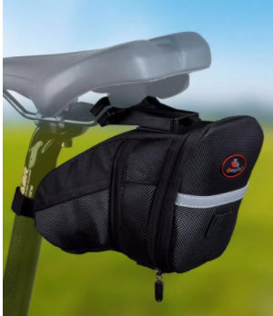 Black bicycle saddle bag attached to a bike seat with a blurred green background