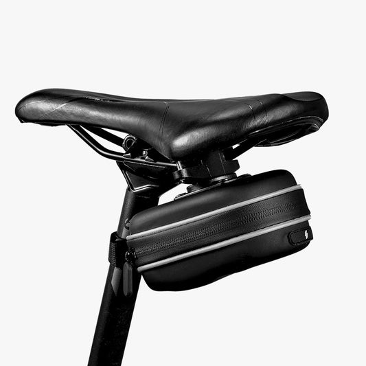 Bicycle saddle with a black bag attached on a white background
