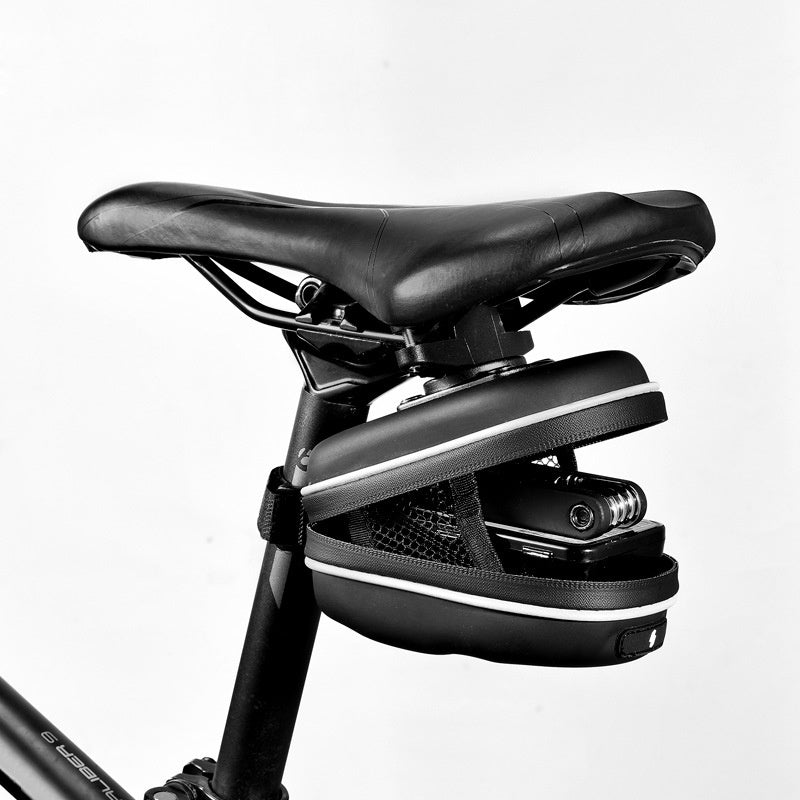 Black bicycle seat with a Compact Bicycle Saddle Bag on a white background