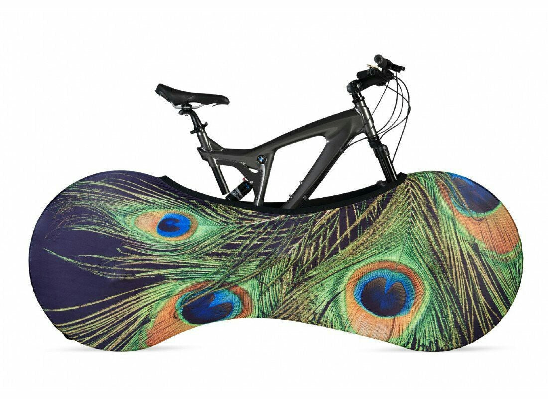 Bicycle inside a peacock feather-patterned cover on a white background